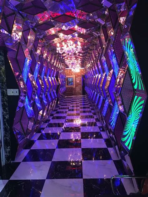 The Hallway Is Decorated In Purple And Black With Lots Of Mirrors On