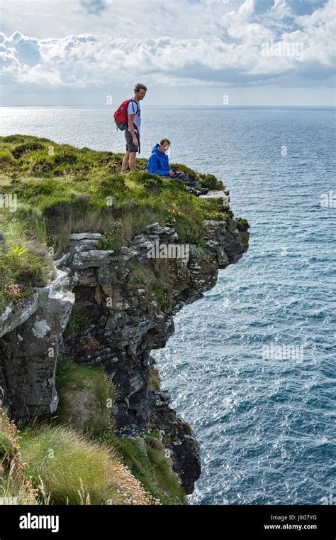 Two People On Cliff Edge Hi Res Stock Photography And Images Alamy