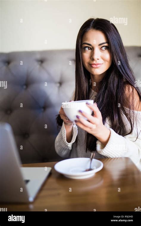 Young Beautiful Woman Drinking Coffee At Cafe Bar Stock Photo Alamy