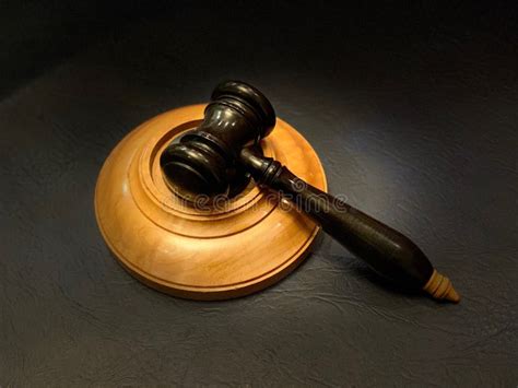 Black Wooden Gavel With Its Block In A Pool Of Light Stock Image