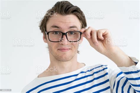 Positive Surprised Young Man Adjusting Glasses In Excitement Stock