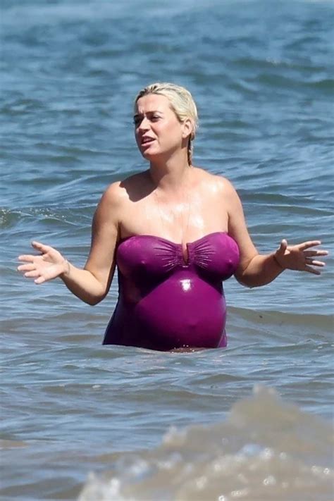 Katy Perry Shows Off Her Massive Baby Bump In A Purple Swimsuit While Enjoying The Beach In