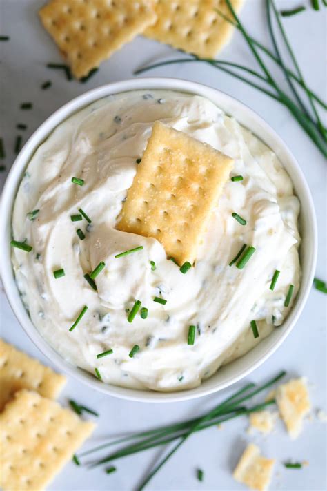 Aerial View Of Garlic Cream Cheese Dip With A Cracker In It And More On The Side With Chopped