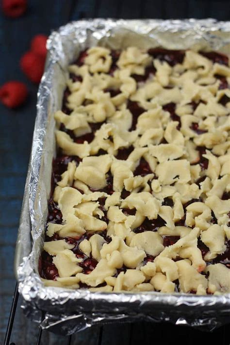 Seedless raspberry jam is spread on the baked crust. Raspberry Bars with Buttery Shortbread Base and Streusel ...