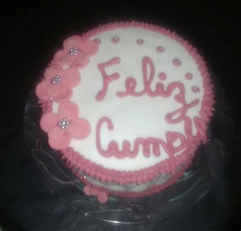 A Cake That Is Sitting On Top Of A Glass Plate With The Words Feliz