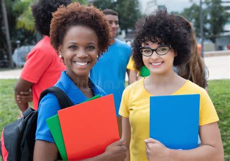 African American And Caucasian Female Student With Group Of Multiethnic