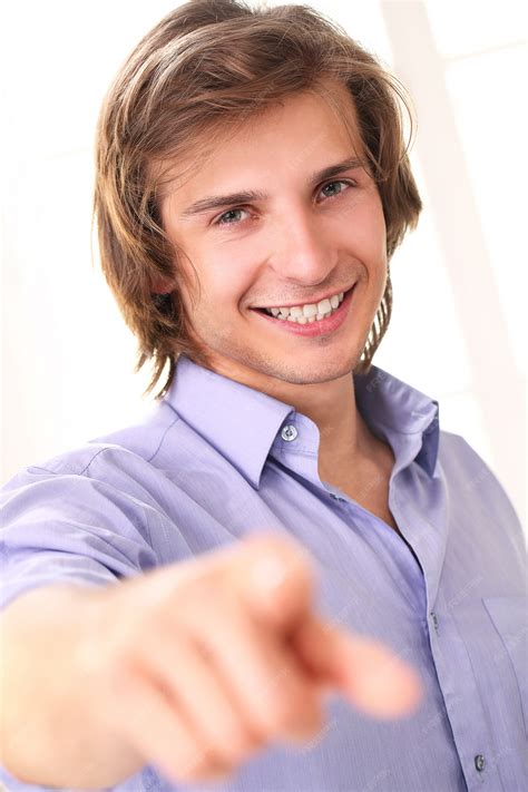 Free Photo Handsome Smiling Guy Pointing At Camera