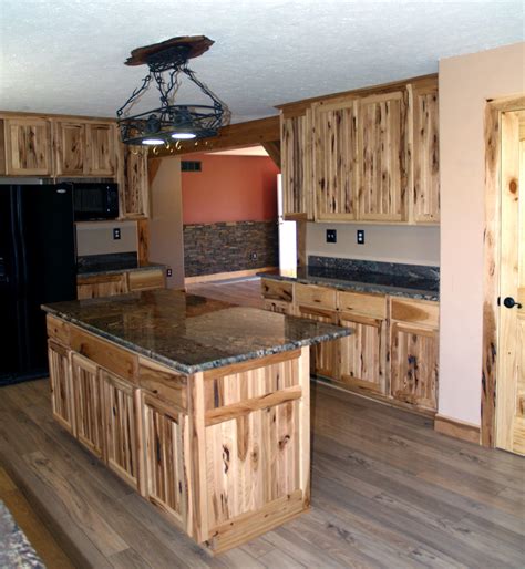 We could mention wooden hoods, furniture style islands, specialty cabinets, decorative accessories, carved moldings, curved moldings, iron, carved design such as enkeboll products, simple wooden or even hidden counter top supports, but that is only scratching the surface of what is possible with our amish craftsmen. Rustic Hickory Kitchen Cabinets - Rustic - Kitchen - Cleveland - by Ohio Amish Cabinet