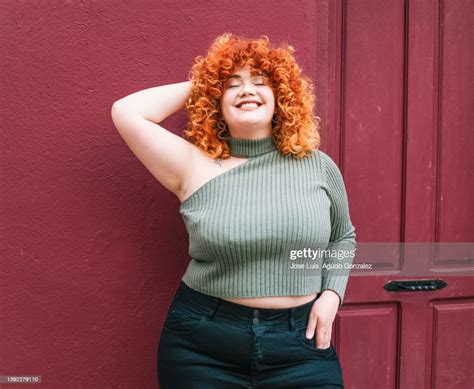 Portrait Of Smiling Chubby Redhead Young Woman Portrait Of Chubby Redhead Woman Outdoors Very