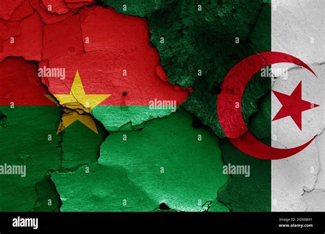 Flags Of Burkina Faso And Algeria Painted On Cracked Wall Stock Photo