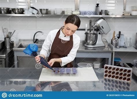 Chocolatier Pours The Chocolate Into The Molds Stock Image Image Of