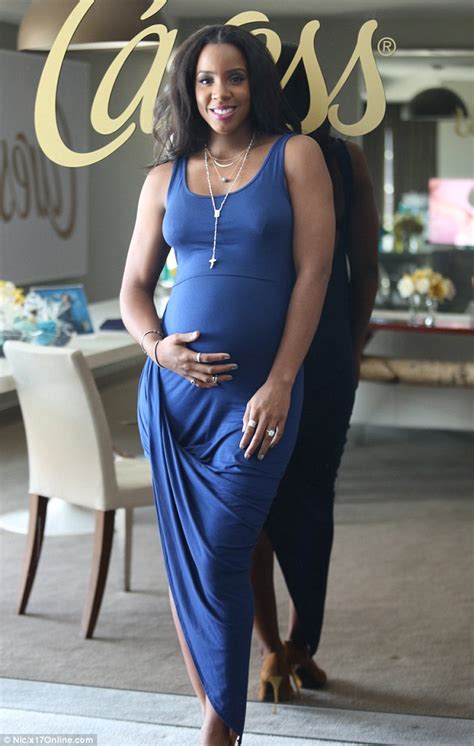 Kelly Rowland Flashes Smile As She Holds Pregnant Belly In