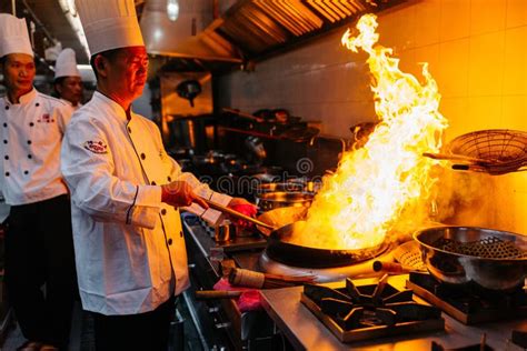 Chef Cooking Chinese Food With Burning Fire On Steel Pan Editorial