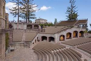 An Old Theatre With Rows Of Seats And Trees