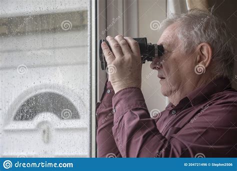 Nosy Neighbor Looking Through Window With Binoculars On A Rainy Day