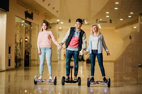 Man And Two Woman Riding On Hoverboard In Mall Stock Image Image Of Board Selfbalancing