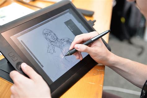Person Holding Black Tablet Computer Pen Drawing Comic Artist