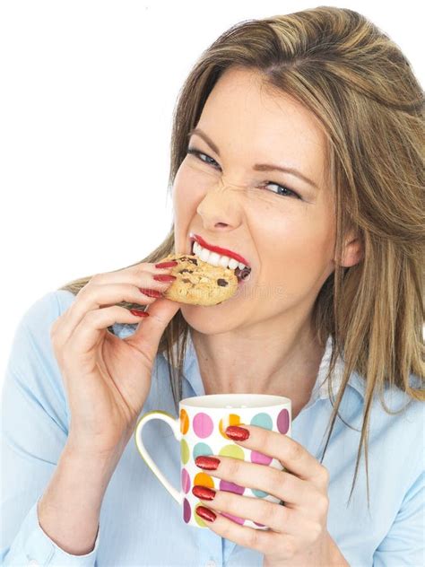 Attractive Pretty Young Woman Eating Biscuit Holding Blue Mug Tea Stock