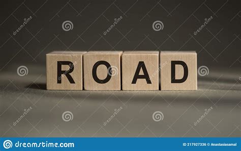 A Wooden Blocks With The Word Road Written On It On A Gray Background