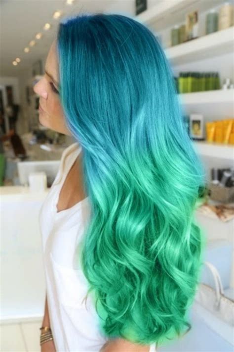 This super colorful style was created to be reminiscent of a mermaid, with saturated blue on the top half of the hair, transitioning into a bright aqua turquoise on the bottom section. Hajak