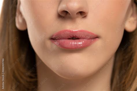 Beautiful Puffy Feminine Lips With Nude Lipstick On White Stock Photo