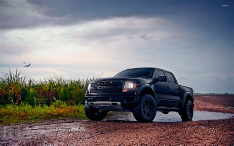 Front side view of a black ford f-150 raptor wallpaper