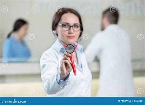 Portrait Of Woman Doctor At Hospital Corridor Looking At Camera Stock