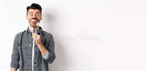 Handsome Positive Guy Showing White Perfect Smile With Magnifying Glass