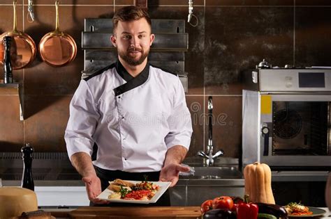 Pleasant Chef Representing Tasty Beautifully Decorated Dish At Master