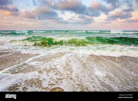 Sea Tide On A Cloudy Sunset Green Waves Crashing Golden Sandy Beach