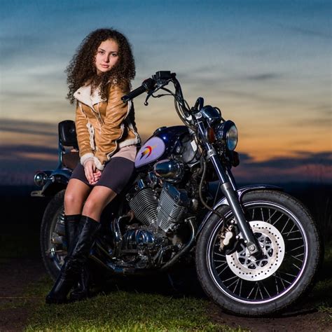 Premium Photo Beautiful Girl Is Sitting On A Motorcycle In The Evening