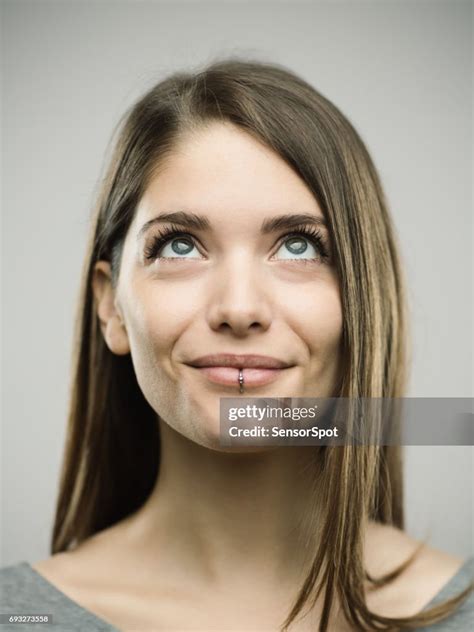 Real Happy Young Woman Studio Portrait Looking Up High Res Stock Photo