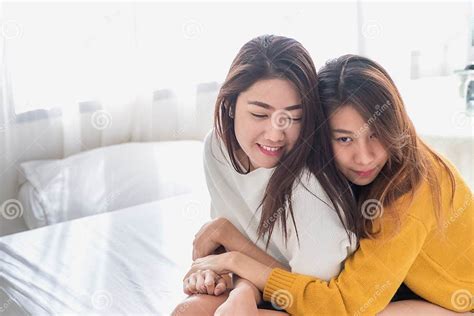 Asia Lesbian Lgbt Couple Hug And Sitting On Bed Near White Window Sunlight With Happiness Moment