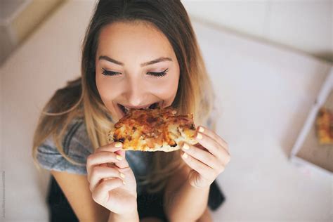 Happy Young Woman Eating Pizza By Stocksy Contributor Jovana Rikalo Stocksy