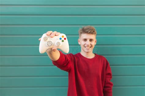 Gamer With A Gamepad In His Hands Playing Console Games Looking Into