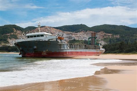 Premium Photo Abandoned Cargo Ship Sailing On The Beach