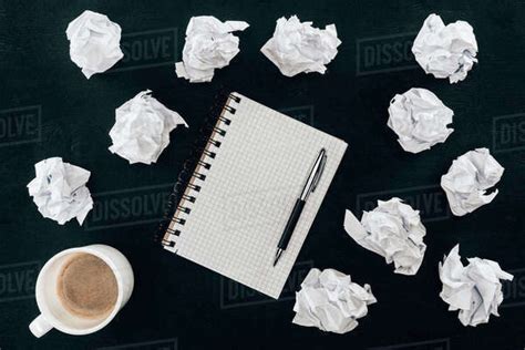 Top View Of Blank Notepad With Messy Crumpled Papers And Cup Of Coffee