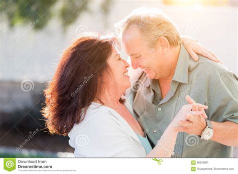 Middle Aged Couple Enjoy A Romantic Slow Dance Outside Stock Image