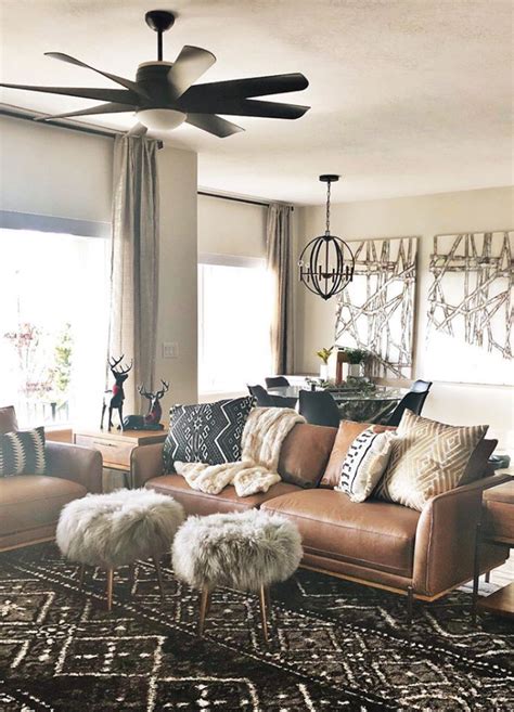 A dream theme of ornate lamps, brown wooden boxes, and plush sofas is knit together by the magical warm light in this romantic sitting room. Living Room, modern boho, leather, tribal, bohemian ...