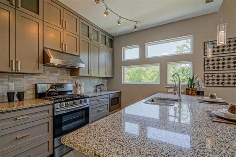 Planning to renovate your kitchen but have no idea where to start? Neutral cabinets and stone countertops give this kitchen a ...