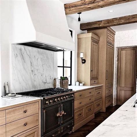 No more dark stains for these cabinets! Natural wood cabinets, bronze hardware, plaster hood ...