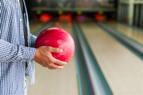Person Holding A Red Bowling Ball Free Photo