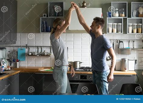 Happy Romantic Couple Dancing In The Kitchen While Cooking Toget Stock Photo Image Of Life