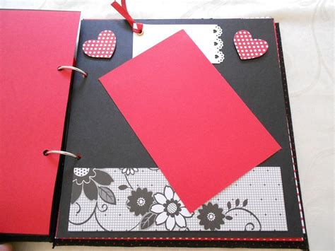 An Open Book With Red Paper And Hearts On It