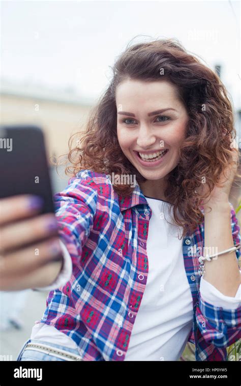 Young Woman Using Smartphone To Take A Selfie Stock Photo Alamy
