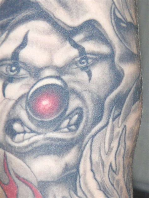 close up clown left arm tattoo