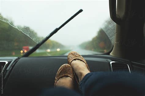 Woman Rides With Her Feet On The Dash Of A Car By Kelly Knox Stocksy