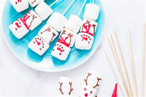 Premium Photo Close Up View Making Marshmallow Snowman And Reindeer On Sticks For Hot