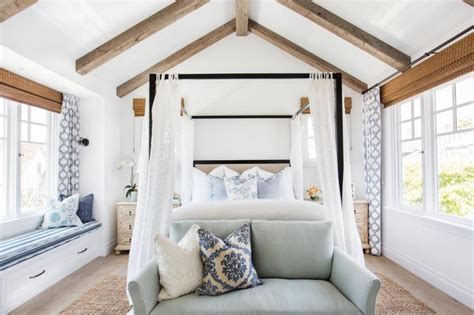 This is an example of a small contemporary master bedroom in los angeles with white walls, medium hardwood flooring, brown floors, a vaulted ceiling and no fireplace. Designs Of How Vaulted Ceilings Top Off Any Room With Style