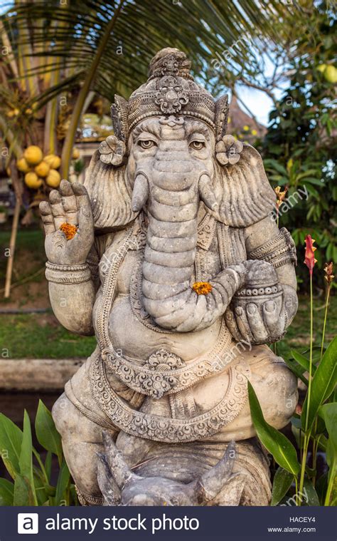 Stone Ganesha Statue With Flowers In The Garden Stock Photo 126894296